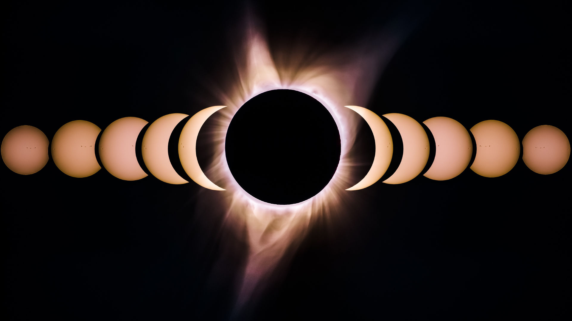 A total solar eclipse: a black disc ringed by a white corona against a dark sky.